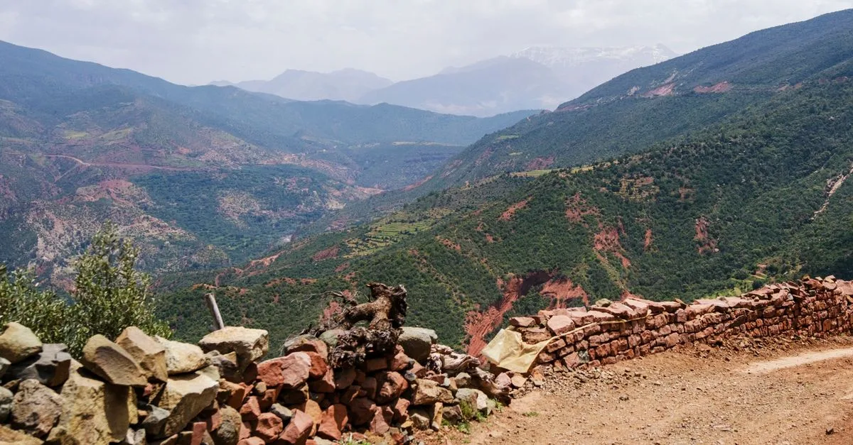 Breathtaking landscape of the Atlas Mountains featuring rugged terrain and lush greenery in Morocco.