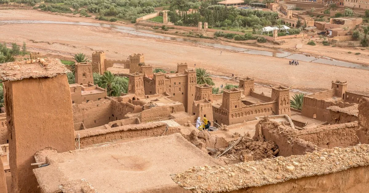 Explore the ancient Moroccan kasbah amid a stunning desert oasis. Ideal travel destination for history enthusiasts.