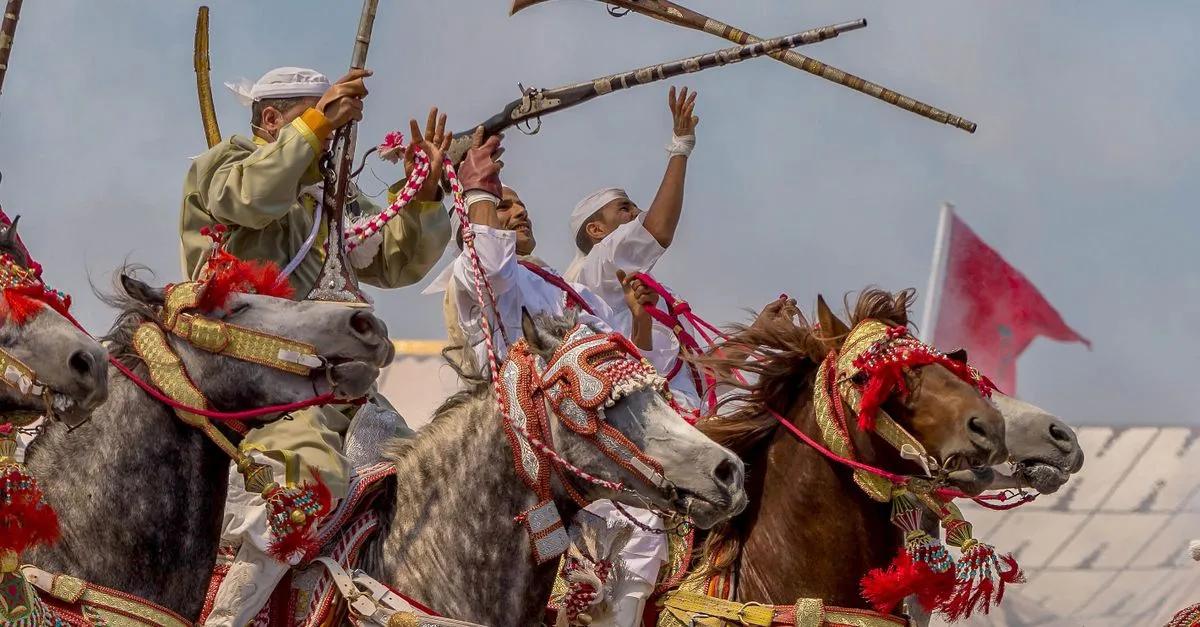 Vibrant display of Moroccan horsemen in traditional Fantasia festival showcasing culture and horsemanship.