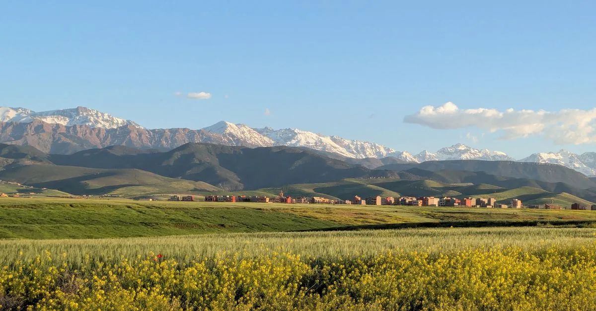 Beautiful view of the Atlas Mountains and fields in Marrakesh, Morocco during the day.