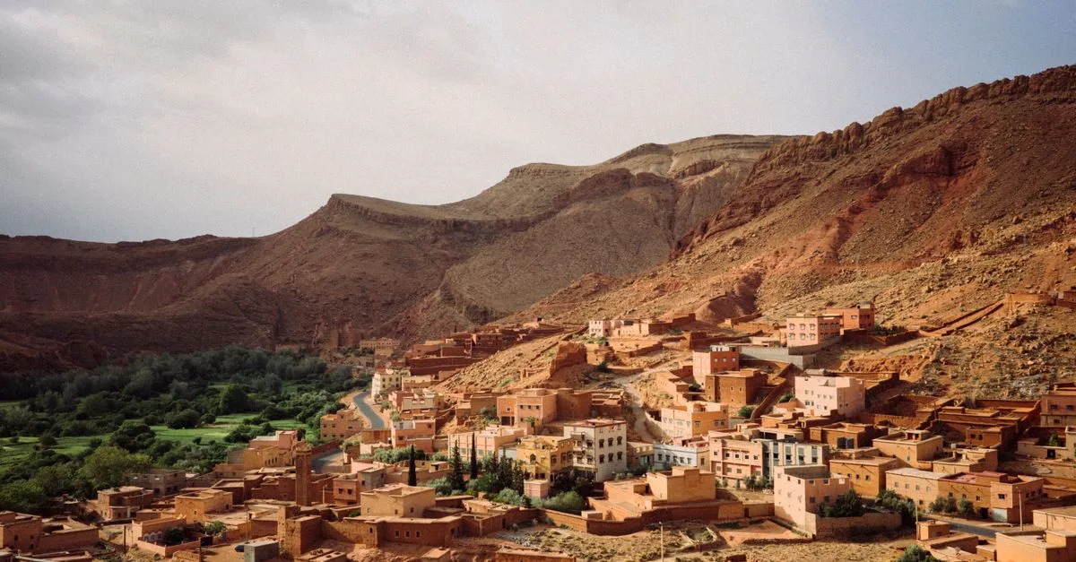 Scenic aerial view of a traditional village in Morocco surrounded by desert mountains.